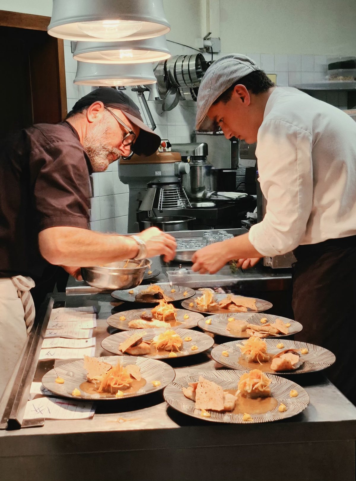 Deux chefs dressent une série d’assiettes